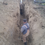 Fritz and Josh installing an underground water line